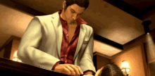 a man in a suit and red shirt is standing next to a woman