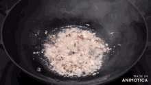 a pot of food is being cooked with the words made in animotica visible