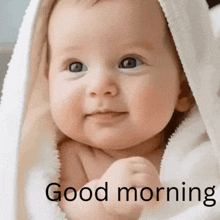 a baby wrapped in a white blanket with the words " good morning " written below it