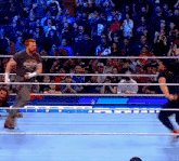 a man in a wrestling ring with a crowd behind him and a sign that says wwe