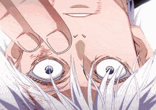 a close up of a person 's face with their hand on their face