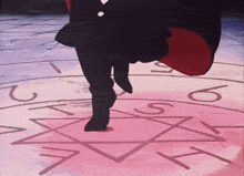 a person 's feet are standing on a pink circle with the letters a and t on it