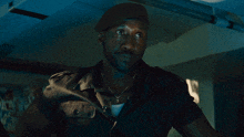 a man with a beard wears a black beret