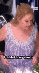 a woman in a purple and white tank top says i tinkled in my shorts