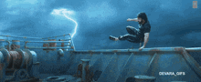 a gif of a man jumping over a railing with devara_gifs below him