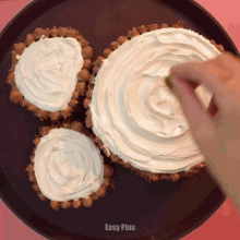 a person spreading whipped cream on top of cupcakes with easy plus written on the bottom