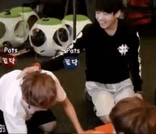 a group of young men are playing a game with pats written on the screen
