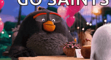an angry bird from the movie the angry birds is sitting at a table with balloons .