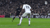 a soccer player with the number 19 on his jersey is kicking a ball