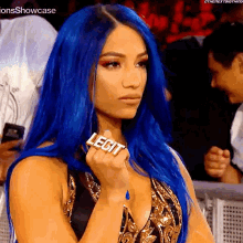 a woman with blue hair is wearing a ring that says legit .