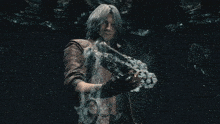 a man in a leather jacket is holding a sword in a dark room