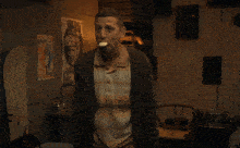 a man with a cigarette in his mouth stands in front of a sign that says im sowy
