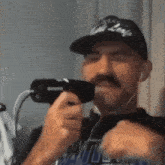 a man with a mustache wearing a hat that says cal league on it