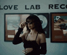 a woman wearing sunglasses stands in front of a wall that says love lab records