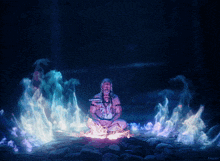 a man sits in a lotus position in front of a fire with the word kepler visible in the corner