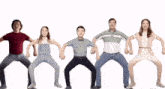 a group of people are dancing in a line