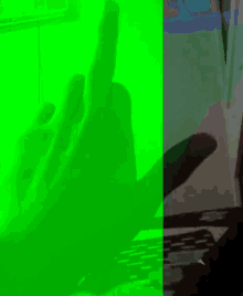 a green screen with a shadow of a hand on it
