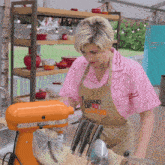 a woman in an apron that says " stand up to cancer "