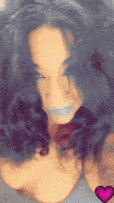 a close up of a woman 's face with a pink heart in the background
