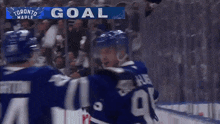 a toronto maple hockey player celebrates a goal with his teammates