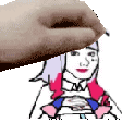 a close up of a person 's hand holding a cartoon character 's head .
