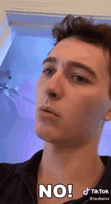 a young man is making a face and says no