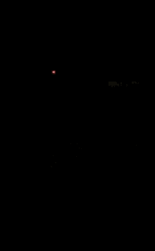 a red light is shining on a dark floor