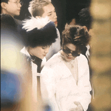a man wearing sunglasses and a white shirt that says " i 'm always a fire "