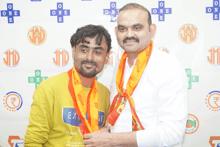 two men are posing for a picture with one wearing a shirt that says exchange