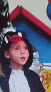 a young boy wearing a pirate hat and a white shirt