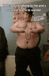 a man without a shirt is wearing a hat and holding a rope around his stomach