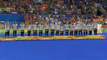 a group of people standing on a podium that says rio 2016 on it