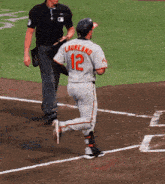 a baseball player with the number 12 on the back of his shirt