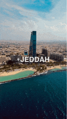 an aerial view of the city of jeddah with a large body of water in the foreground