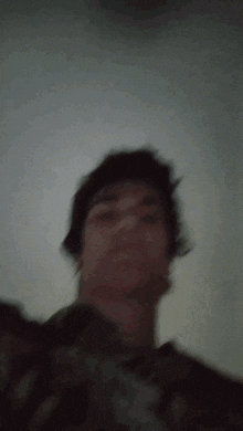 a blurry picture of a man 's face with a gray background