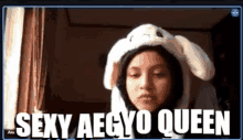 a girl wearing a bunny hat with the words sexy aegyo queen behind her