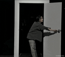 a white door is open to a dark room with syubgiryeok7 written on the bottom