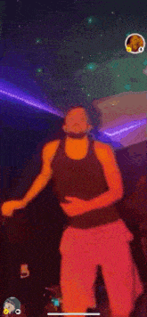 a man is dancing in a dark room with a lot of lights .