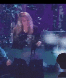 a blurred image of a woman dancing on a stage