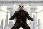 a man in a black suit is sitting on a white chair