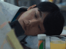 a man is laying on a bed looking at his phone