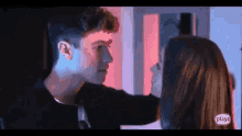 a boy and a girl are looking at each other in a room .
