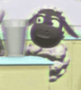 a cartoon sheep with a big smile on its face is sitting on a counter