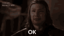 a man with long hair is making a funny face and says ok .