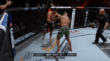 two men are fighting in a boxing ring with a sign that says ufc on it