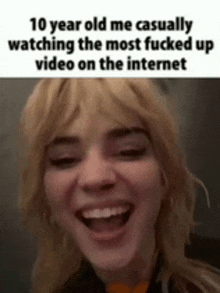 a 10 year old girl is laughing while watching the most fucked up video on the internet .
