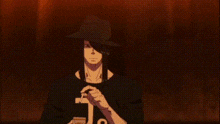 a man is smoking a cigarette in a dark room .