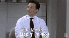 a man in a white shirt and tie is sitting at a desk and saying `` mr. mark ... makin ' copies '' .