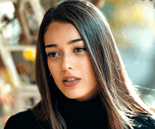 a woman with long hair wearing a black turtleneck