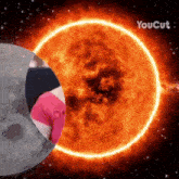 a woman in a pink shirt is standing in front of a burning sun with the words youcut above her